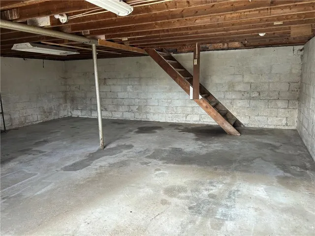 a view of a room with wooden stairs
