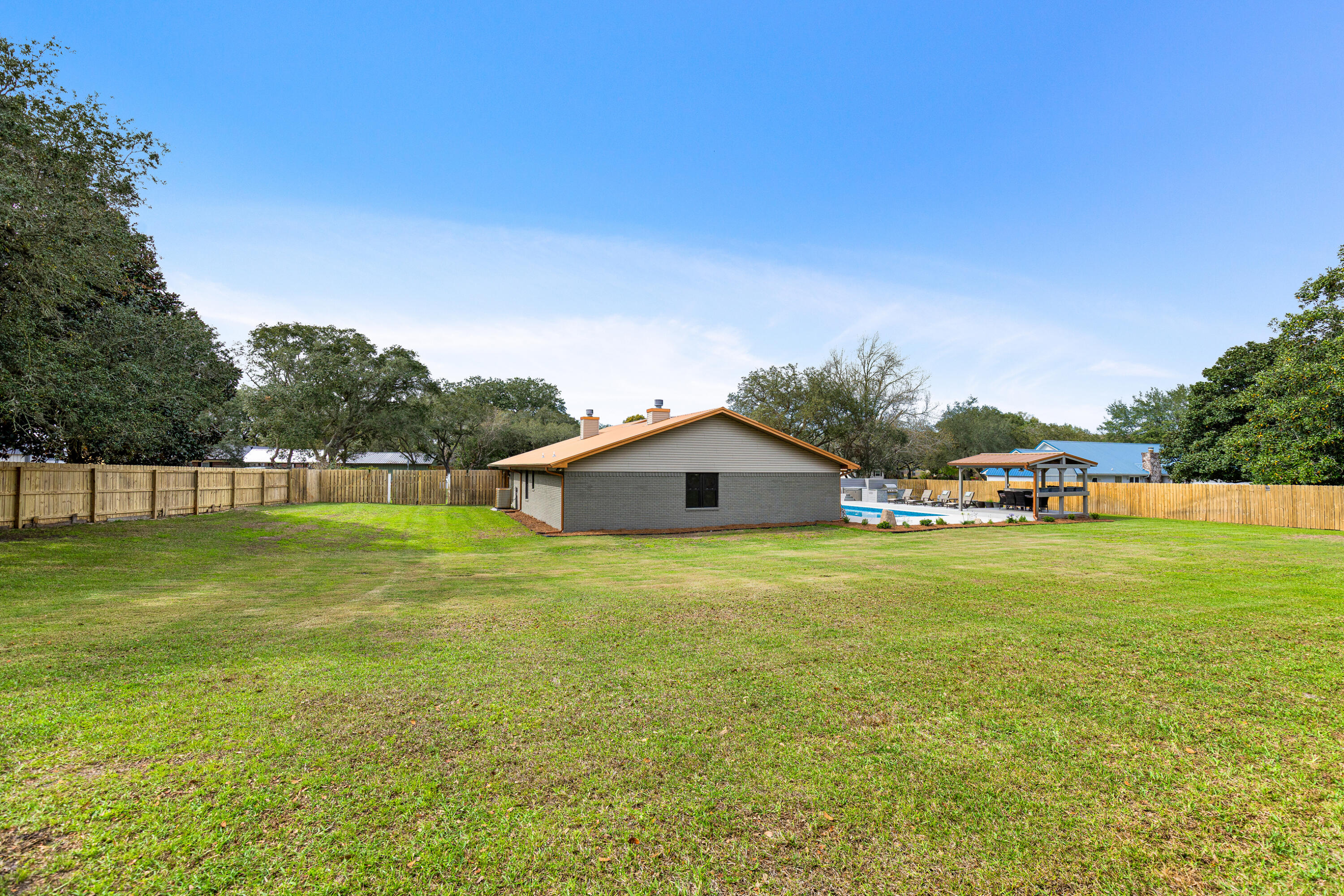 804 Mars Street Destin, FL 32541 - Photo 43 of 71 a front view of a house with a yard and trees