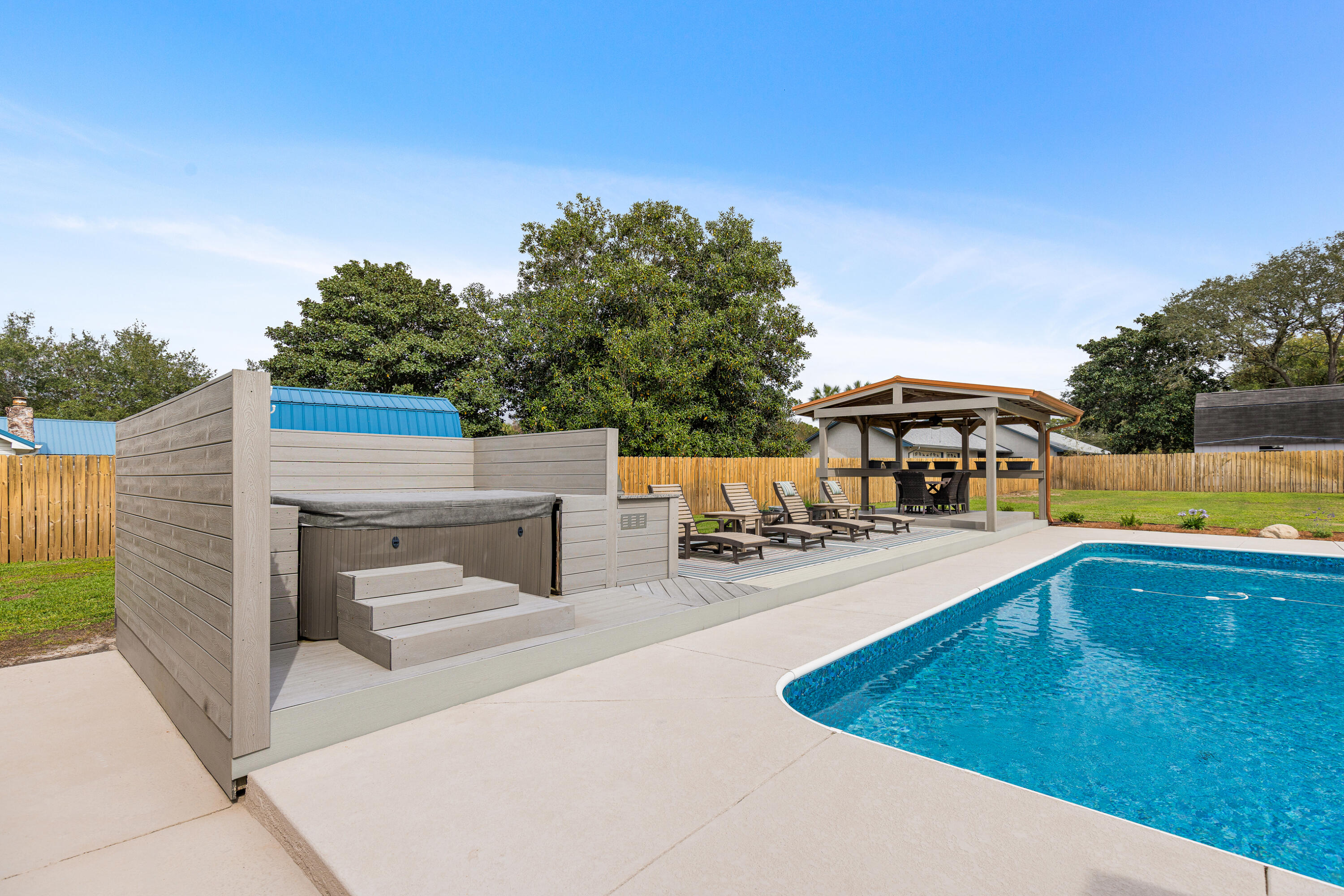 804 Mars Street Destin, FL 32541 - Photo 47 of 71 a view of a swimming pool with an outdoor seating and a garden
