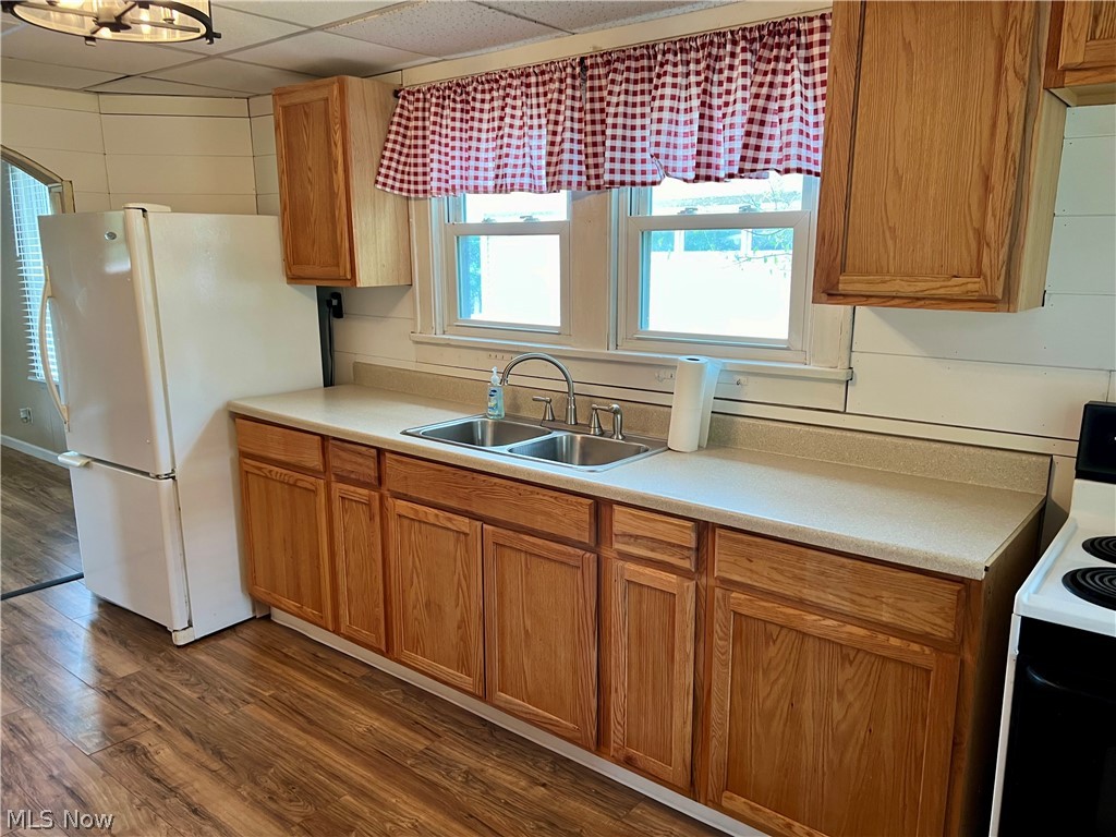 1041 Two Ridge Road Wintersville, OH 43953 - Photo 9 of 19 Kitchen featuring dark hardwood / wood-style floors, a drop ceiling, white appliances, and sink
