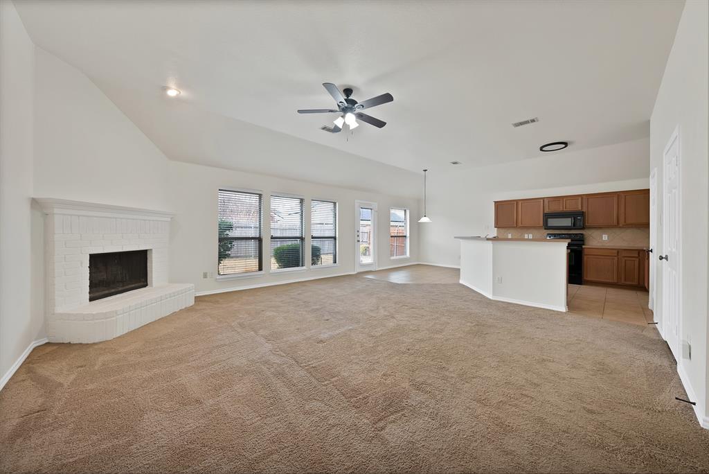 2832 Lone Ranger Trail Little Elm, TX 75068 - Photo 13 of 35 a view of a kitchen with a sink and a fireplace