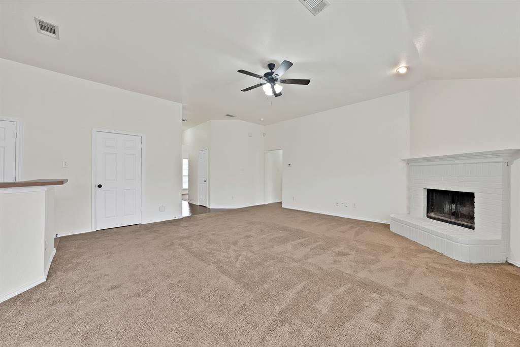 2832 Lone Ranger Trail Little Elm, TX 75068 - Photo 15 of 35 a view of a room with a ceiling fan fireplace and a window