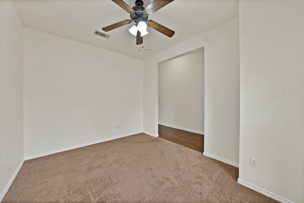 2832 Lone Ranger Trail Little Elm, TX 75068 - Photo 17 of 35 an empty room with a chandelier fan and closet
