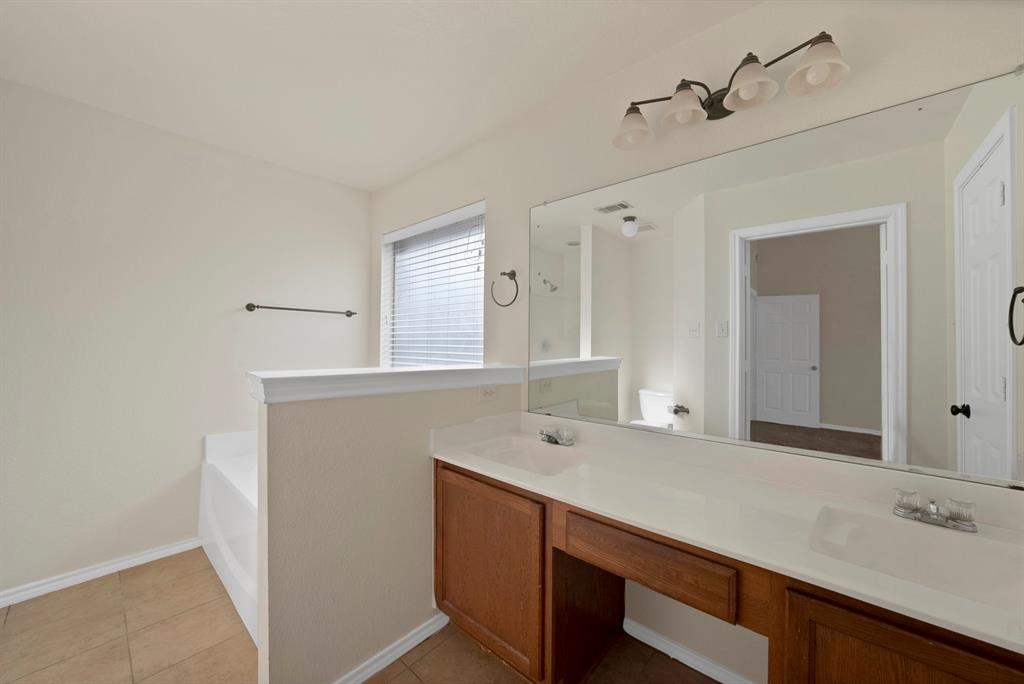 2832 Lone Ranger Trail Little Elm, TX 75068 - Photo 20 of 35 a bathroom with a sink and a mirror