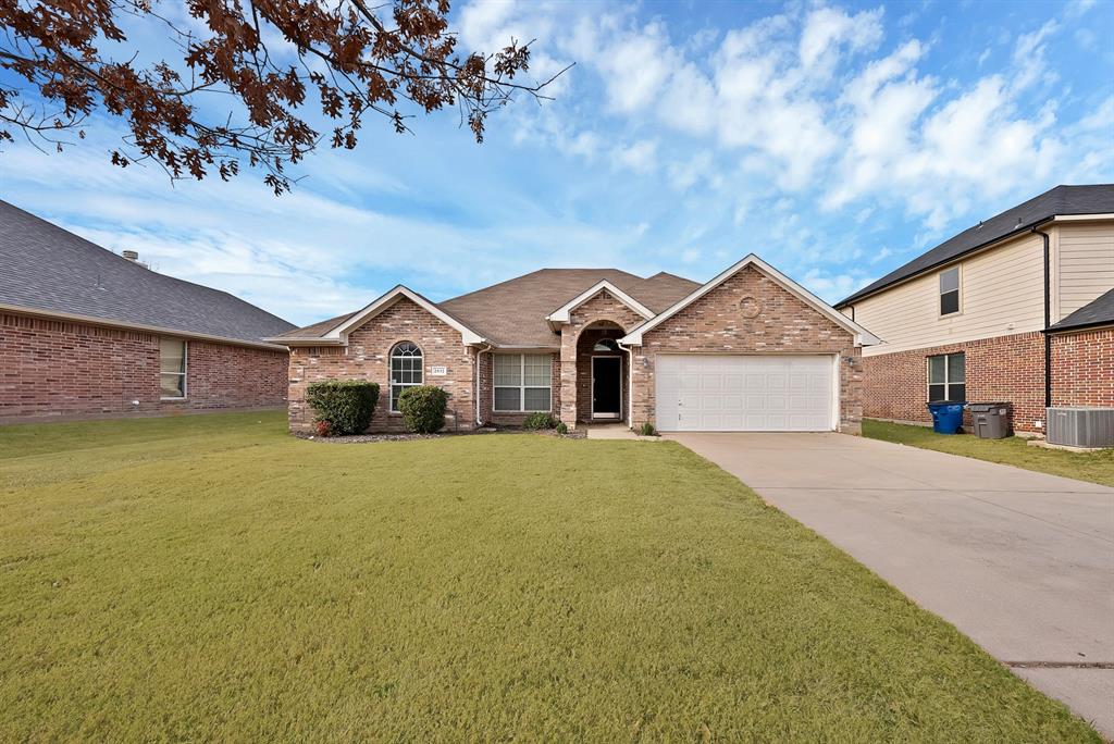2832 Lone Ranger Trail Little Elm, TX 75068 - Photo 2 of 35 a front view of a house with a yard and garage