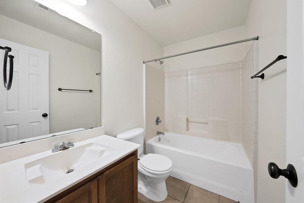 2832 Lone Ranger Trail Little Elm, TX 75068 - Photo 22 of 35 a bathroom with a sink toilet and shower