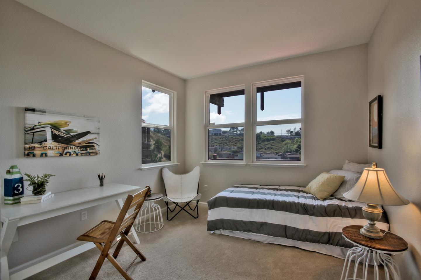 518 A Monterey Road Pacifica, CA 94044 - Photo 33 of 41 a spacious bedroom with a bed and a large window