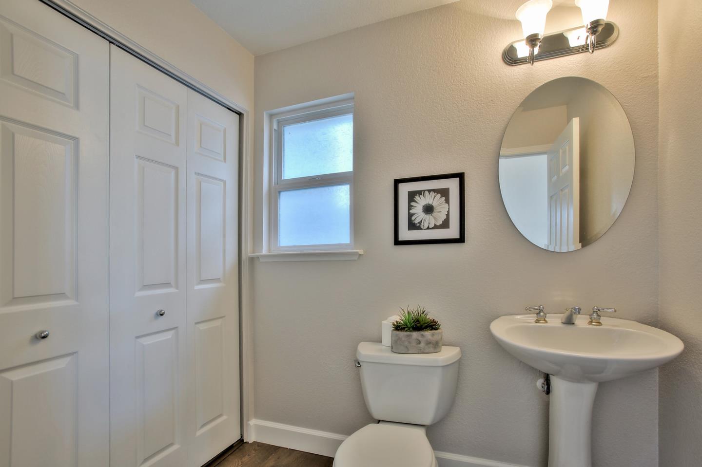 518 A Monterey Road Pacifica, CA 94044 - Photo 36 of 41 a bathroom with a toilet sink and mirror