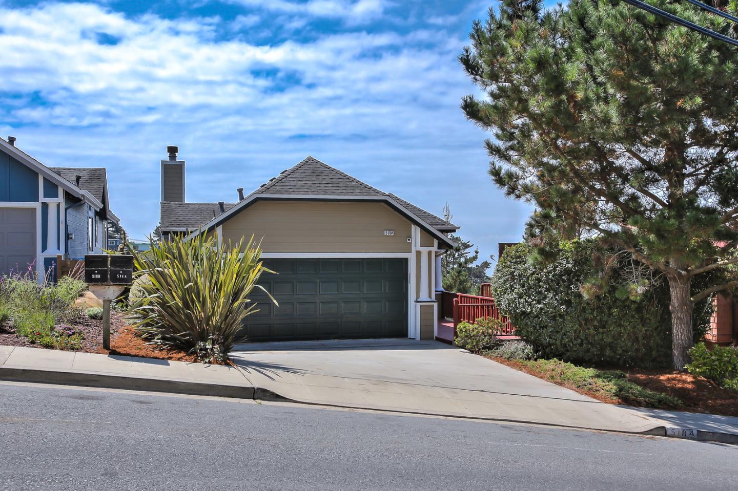 518 A Monterey Road Pacifica, CA 94044 - Photo 5 of 41 a front view of a house with a yard and garage