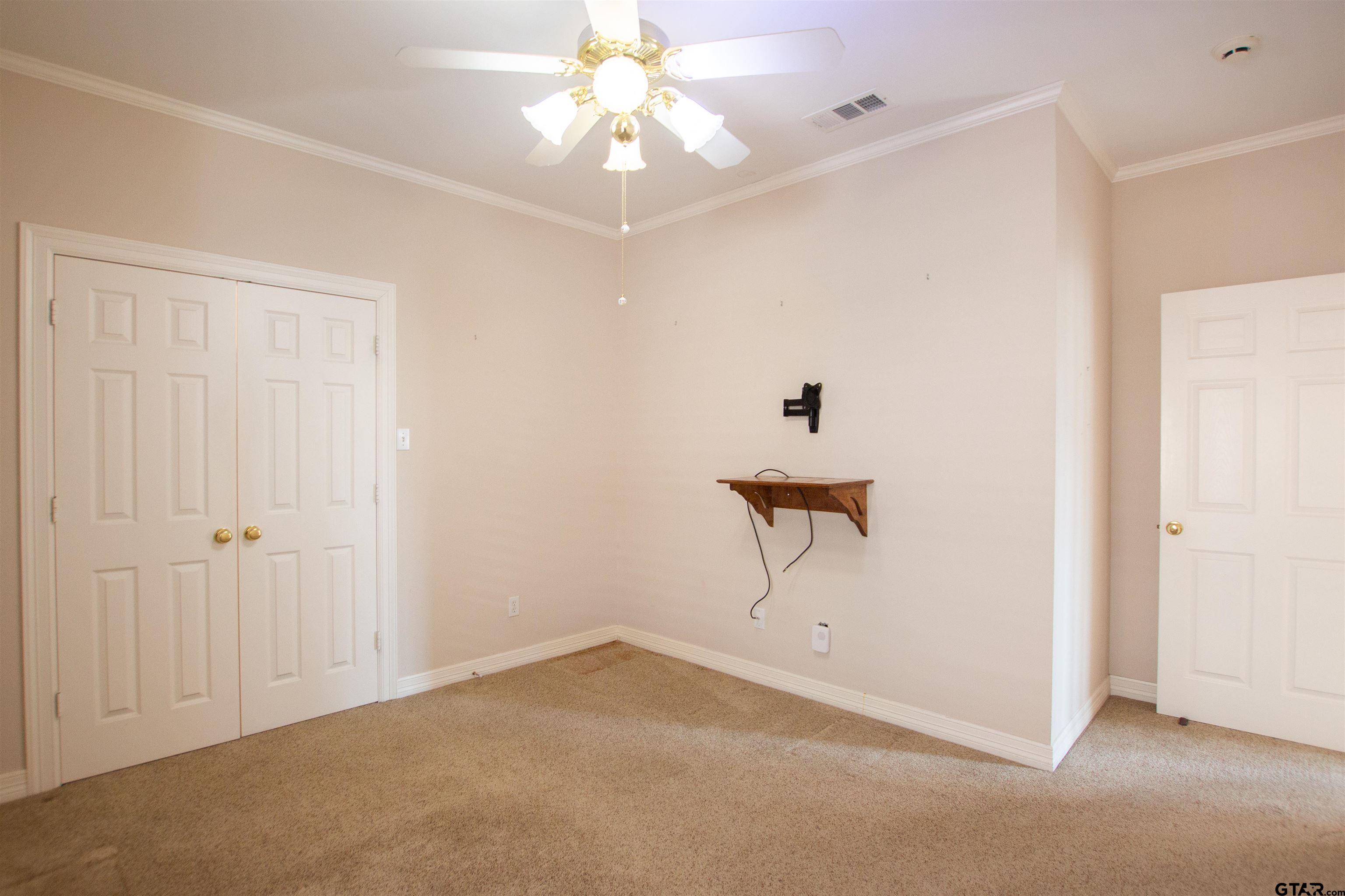 704 Shiloh Ridge Street Tyler, TX 75703 - Photo 30 of 34 an empty room with a ceiling fan and a window