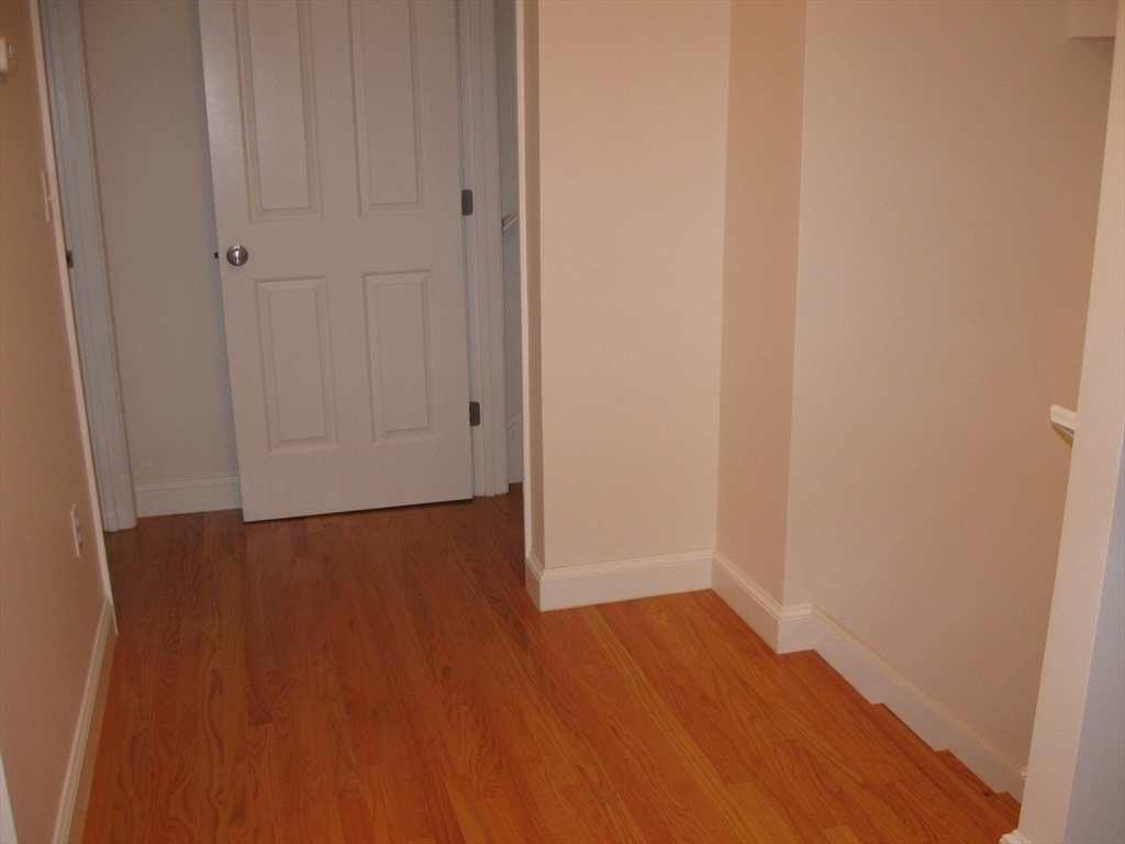 2856 Washington Street Boston, MA 02119 - Photo 35 of 39 a view of an empty room with wooden floor