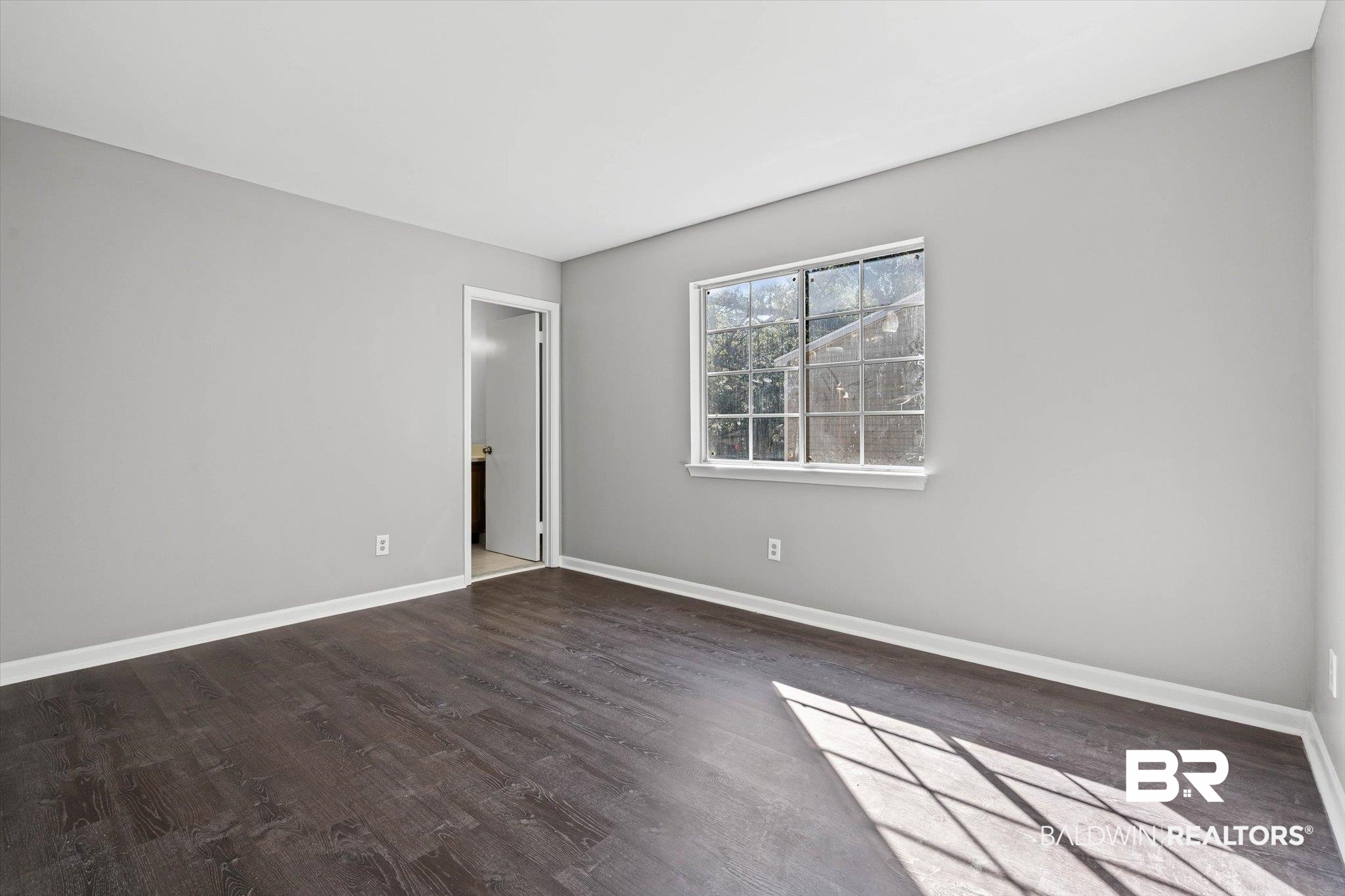 6701 Dickens Ferry Road, Unit 100 Mobile, AL 36608 - Photo 10 of 24 Spare room featuring dark wood-type flooring
