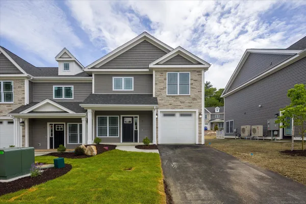 a front view of a house with a yard and porch