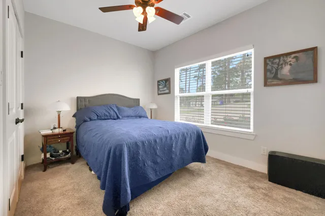 a kitchen with stainless steel appliances granite countertop a sink dishwasher and a dining table with wooden floor