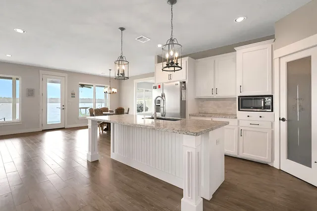 a view of kitchen with refrigerator microwave and stove