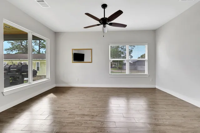 a view of a dining room with furniture window and wooden floor