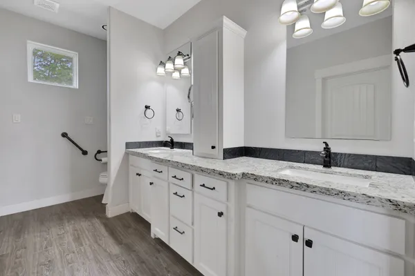 a spacious bathroom with double sink and a mirror