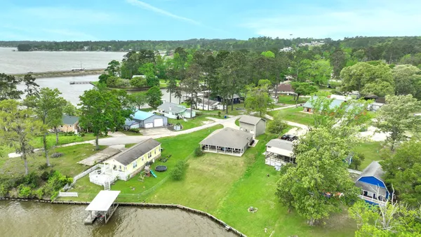a view of a patio with couches chairs and a yard