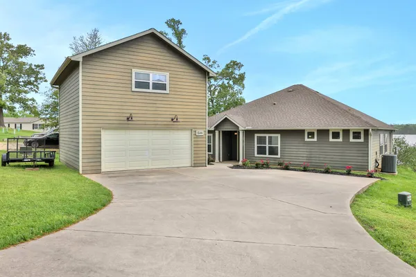 a front view of a house with a yard and a garage