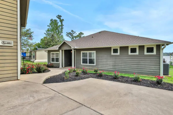a view of a house with a yard and garden