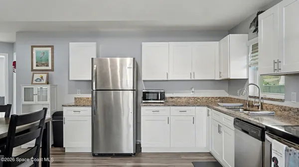 a kitchen with stainless steel appliances granite countertop a refrigerator sink and cabinets