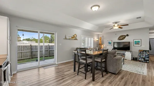 a view of a dining room with furniture window and wooden floor