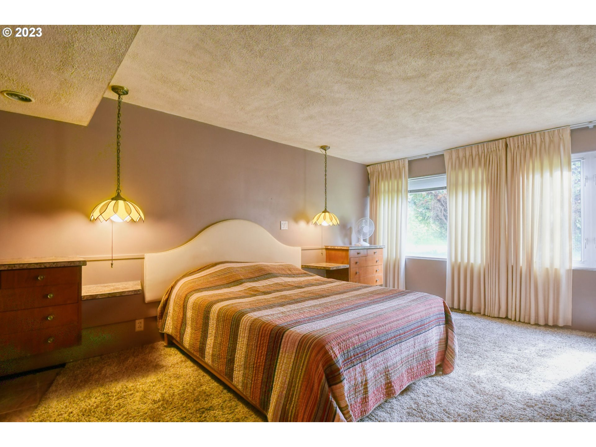 1042 Skyline Drive Pendleton, OR 97801 - Photo 22 of 48 a bedroom with a bed and a chandelier