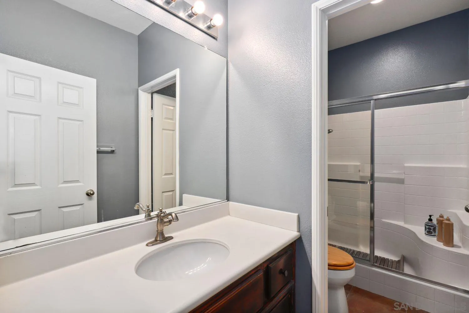 1166 Midnight Way Oceanside, CA 92057 - Photo 14 of 37 a bathroom with a sink and a mirror