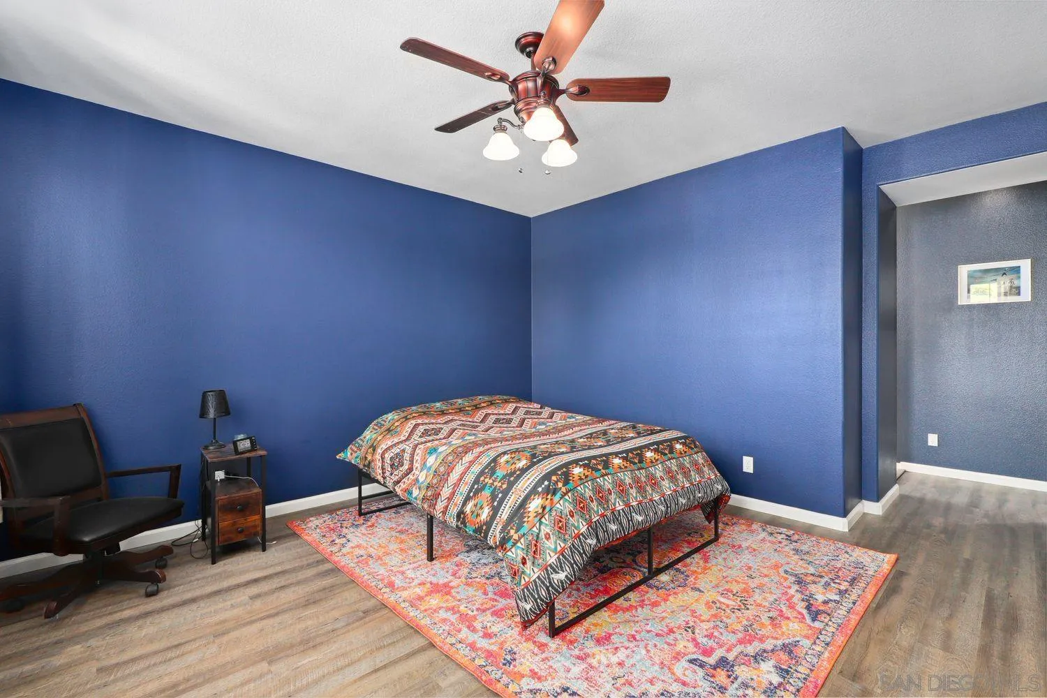 1166 Midnight Way Oceanside, CA 92057 - Photo 16 of 37 a bedroom with a bed and a chandelier