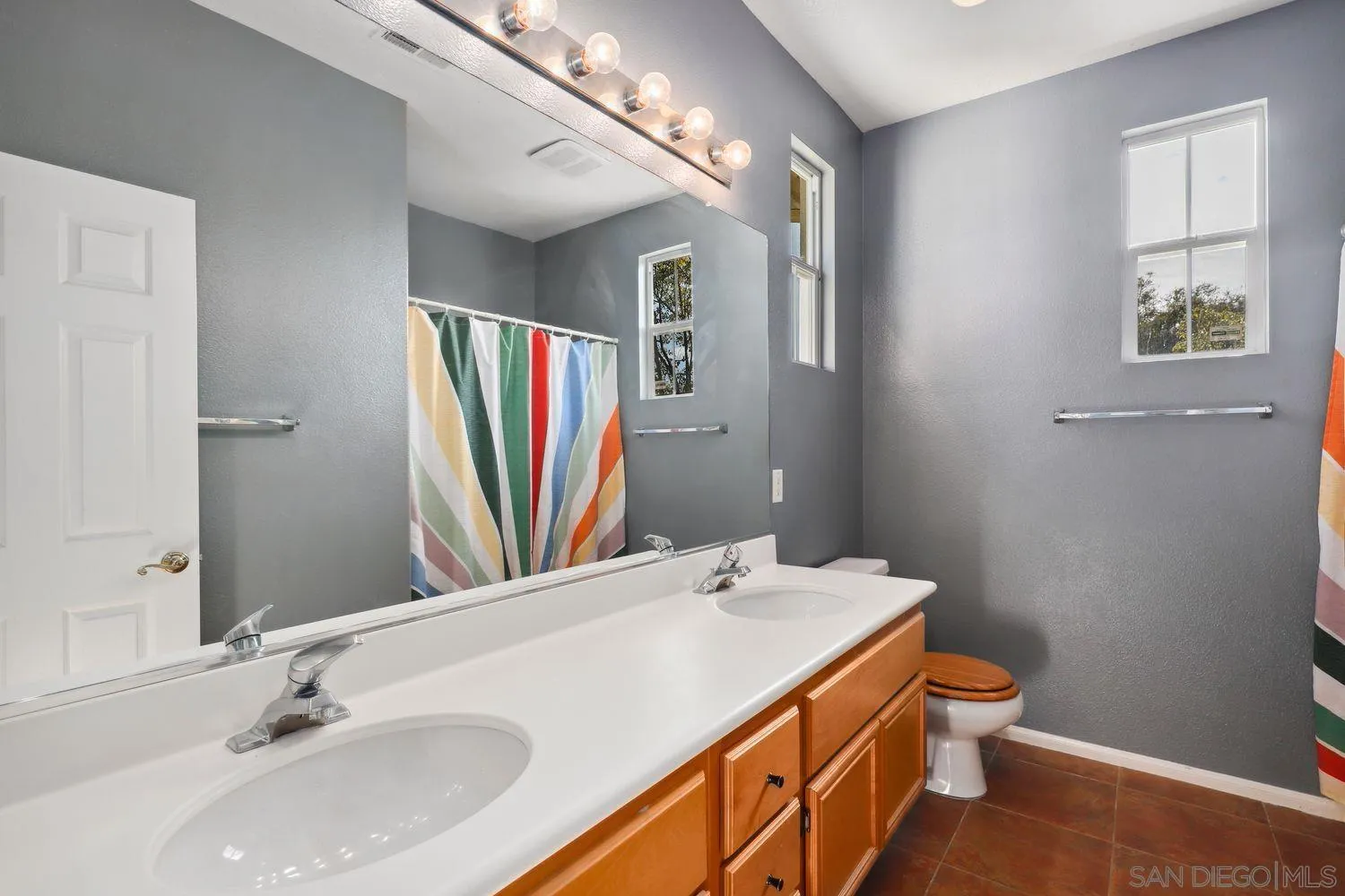1166 Midnight Way Oceanside, CA 92057 - Photo 21 of 37 a bathroom with a sink and a mirror