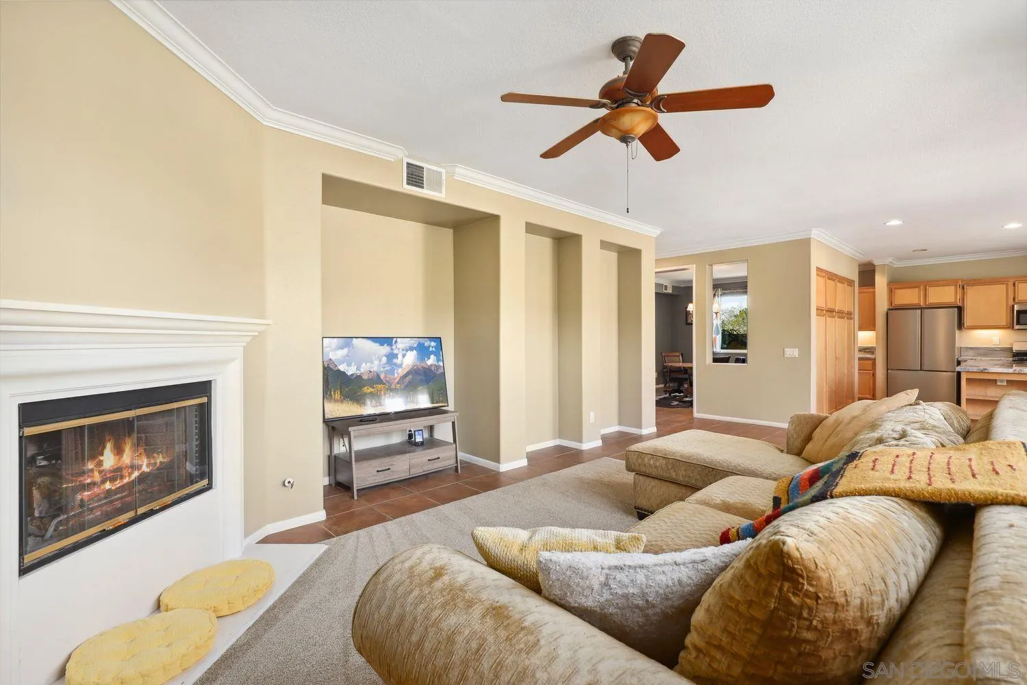 1166 Midnight Way Oceanside, CA 92057 - Photo 4 of 37 a living room with furniture ceiling fan and a fireplace