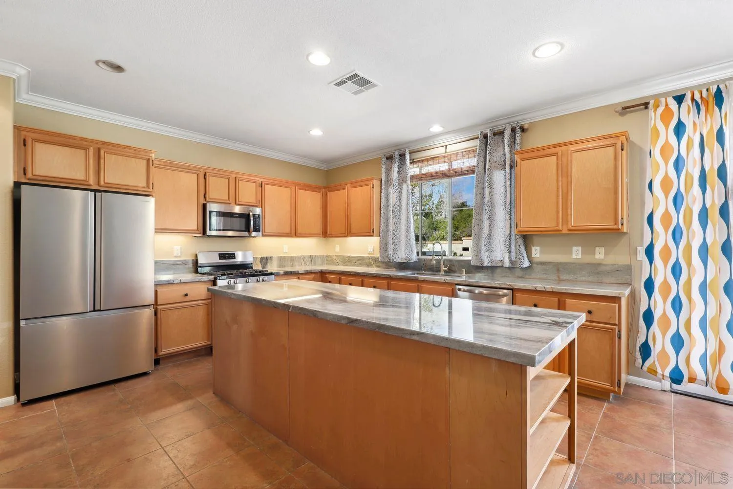 1166 Midnight Way Oceanside, CA 92057 - Photo 6 of 37 a kitchen with stainless steel appliances granite countertop a refrigerator a sink dishwasher a stove and white countertops with wooden floor