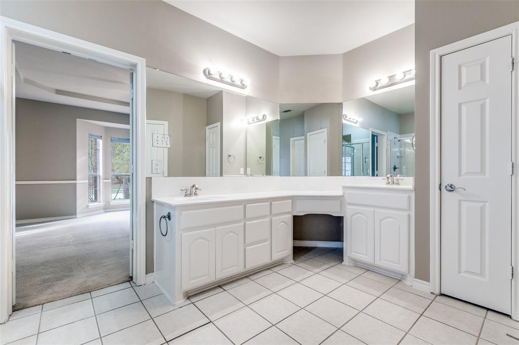 13783 Stevens Point Drive Frisco, TX 75033 - Photo 24 of 25 a spacious en suite bathroom with a double vanity sink and a mirror