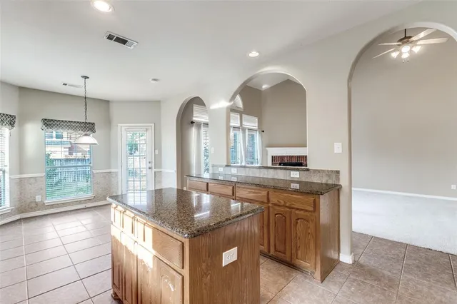 a large kitchen with kitchen island a sink a counter space and stainless steel appliances