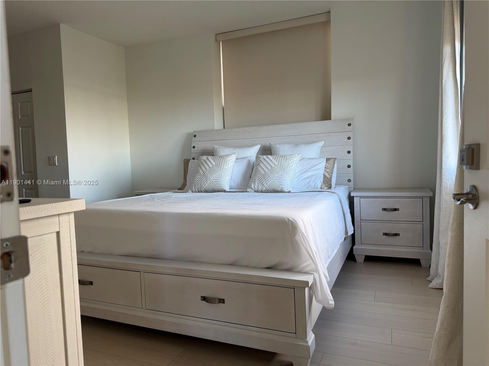 888 Douglas Road, Unit 917 Coral Gables, FL 33134 - Photo 17 of 31 a bedroom with a bed and a flat tv screen on dresser