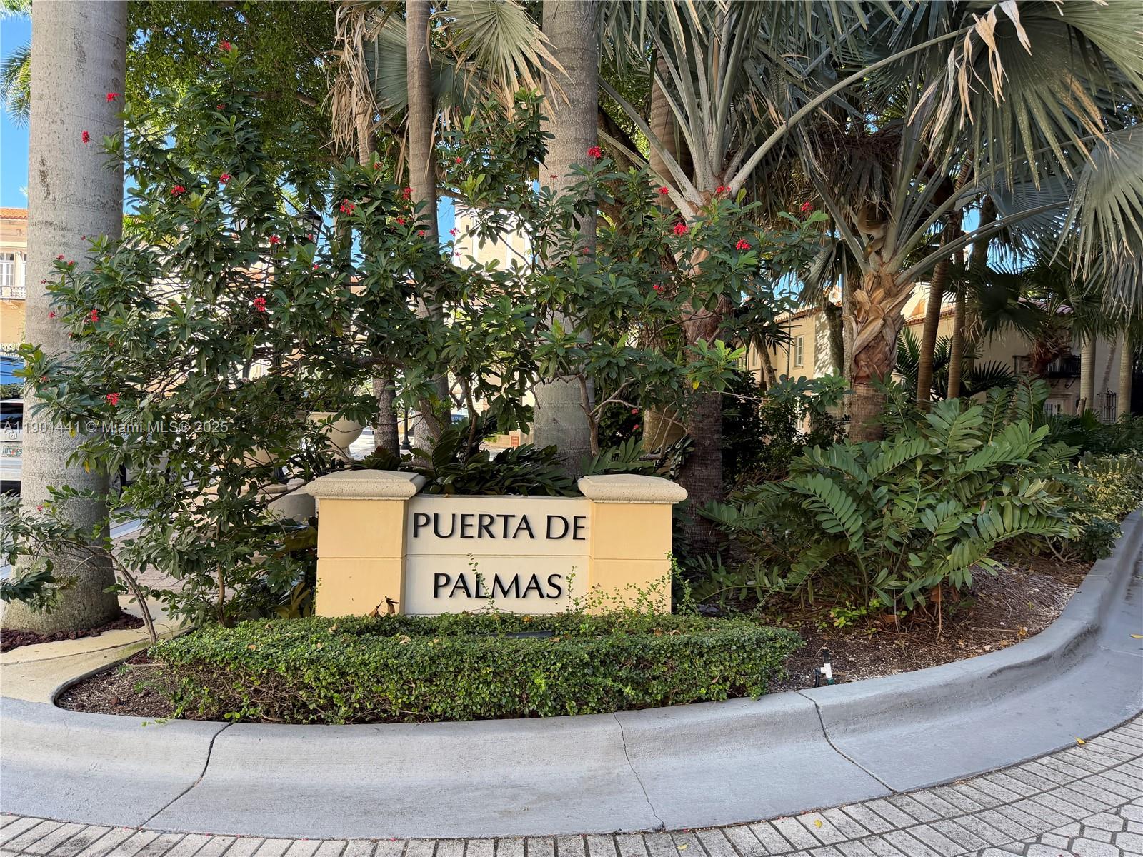 888 Douglas Road, Unit 917 Coral Gables, FL 33134 - Photo 2 of 31 a sign on a wall next to a road