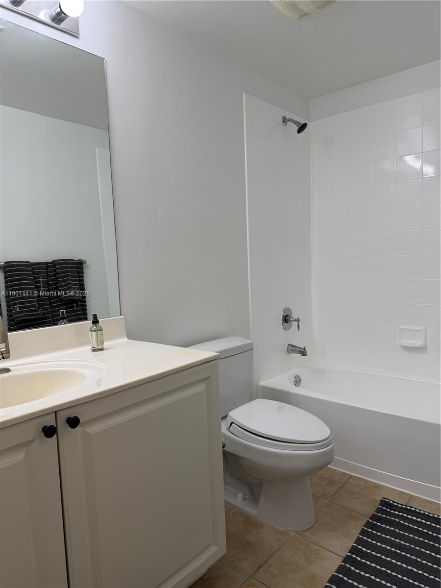 888 Douglas Road, Unit 917 Coral Gables, FL 33134 - Photo 23 of 31 a bathroom with a sink a toilet a mirror and shower