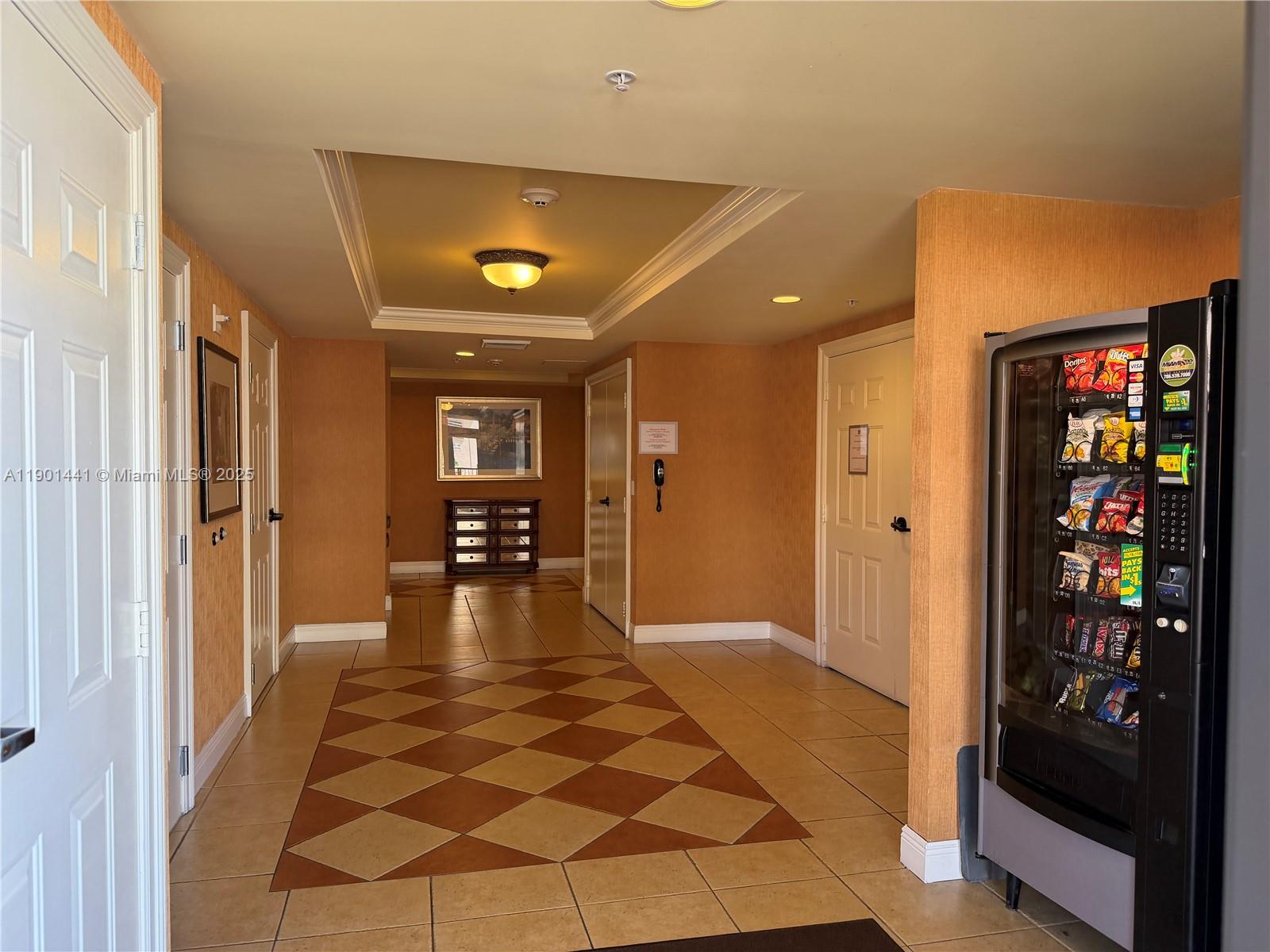 888 Douglas Road, Unit 917 Coral Gables, FL 33134 - Photo 28 of 31 a view of a hallway with wooden floor and furniture