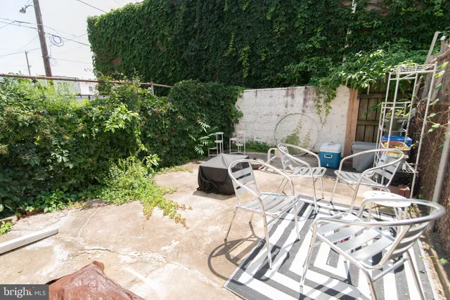 a view of backyard of house with seating space