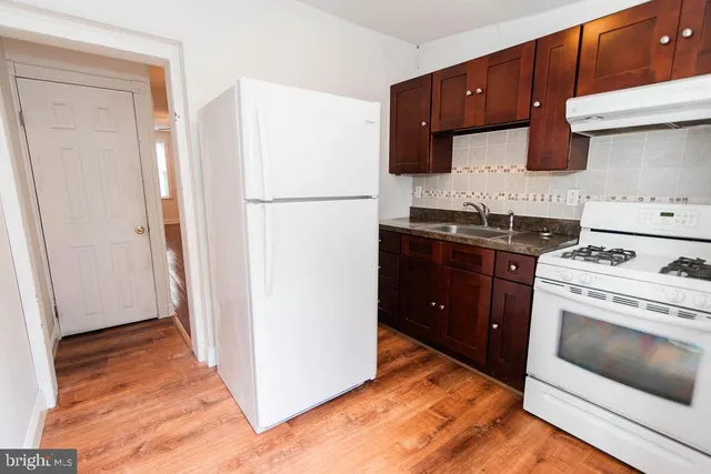 a kitchen with a refrigerator stove and sink