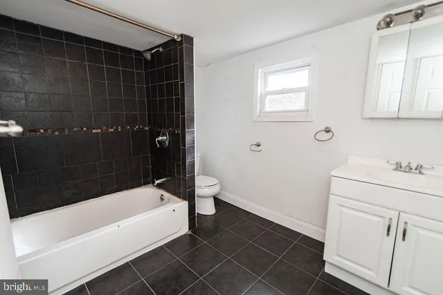 a bathroom with a bathtub a sink a toilet and a shower