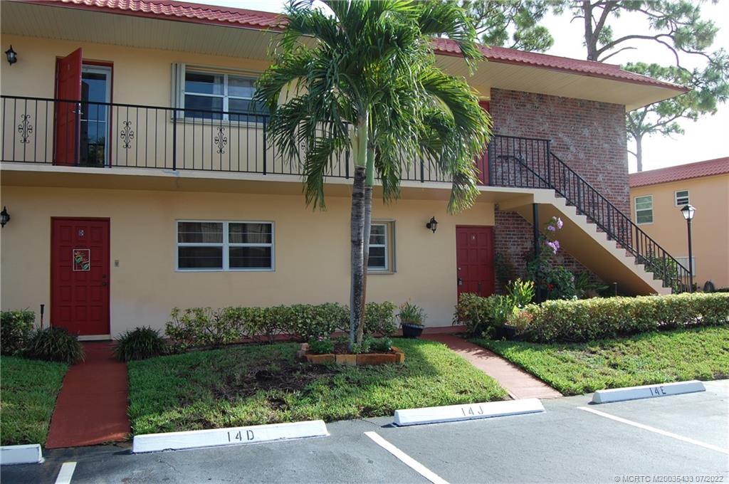 1927 Southwest Palm City Road, Unit E Stuart, FL 34994 - Photo 3 of 30 a front view of house with yard and green space
