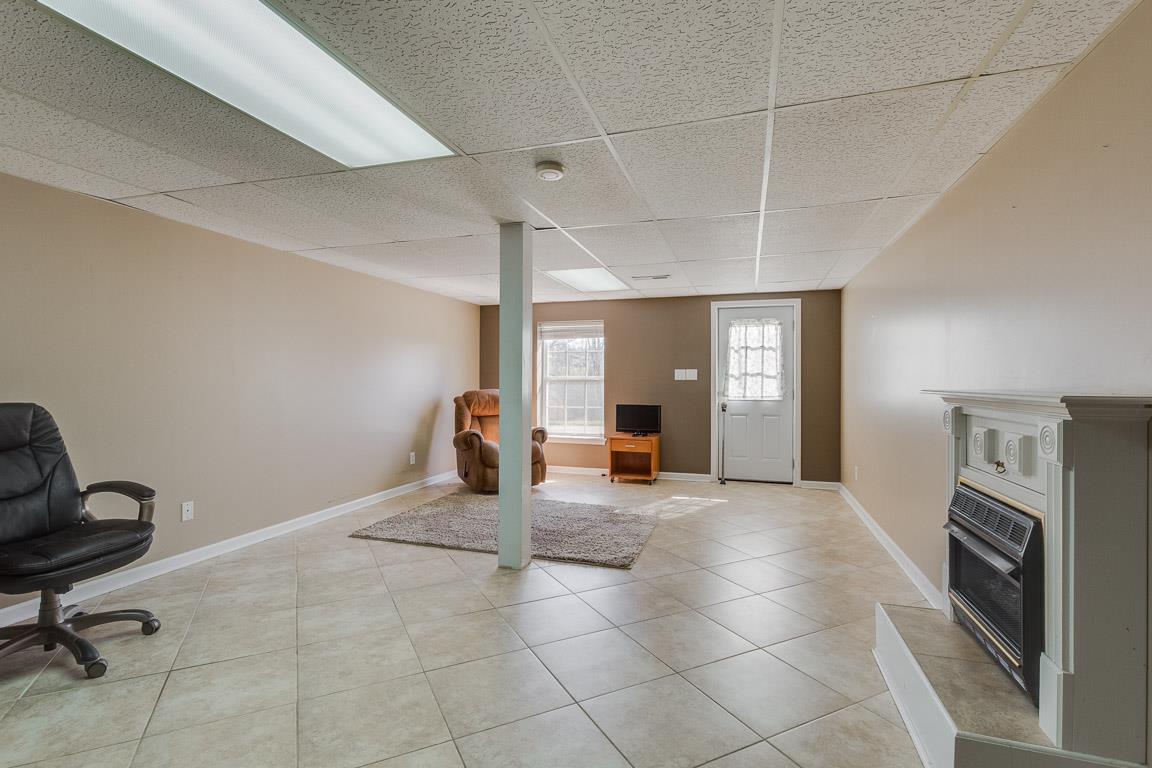 602 Luther Road Dickson, TN 37055 - Photo 21 of 26 Finished Basement Area, Fireplace, Entrance to Rear. Tile..So much potential !