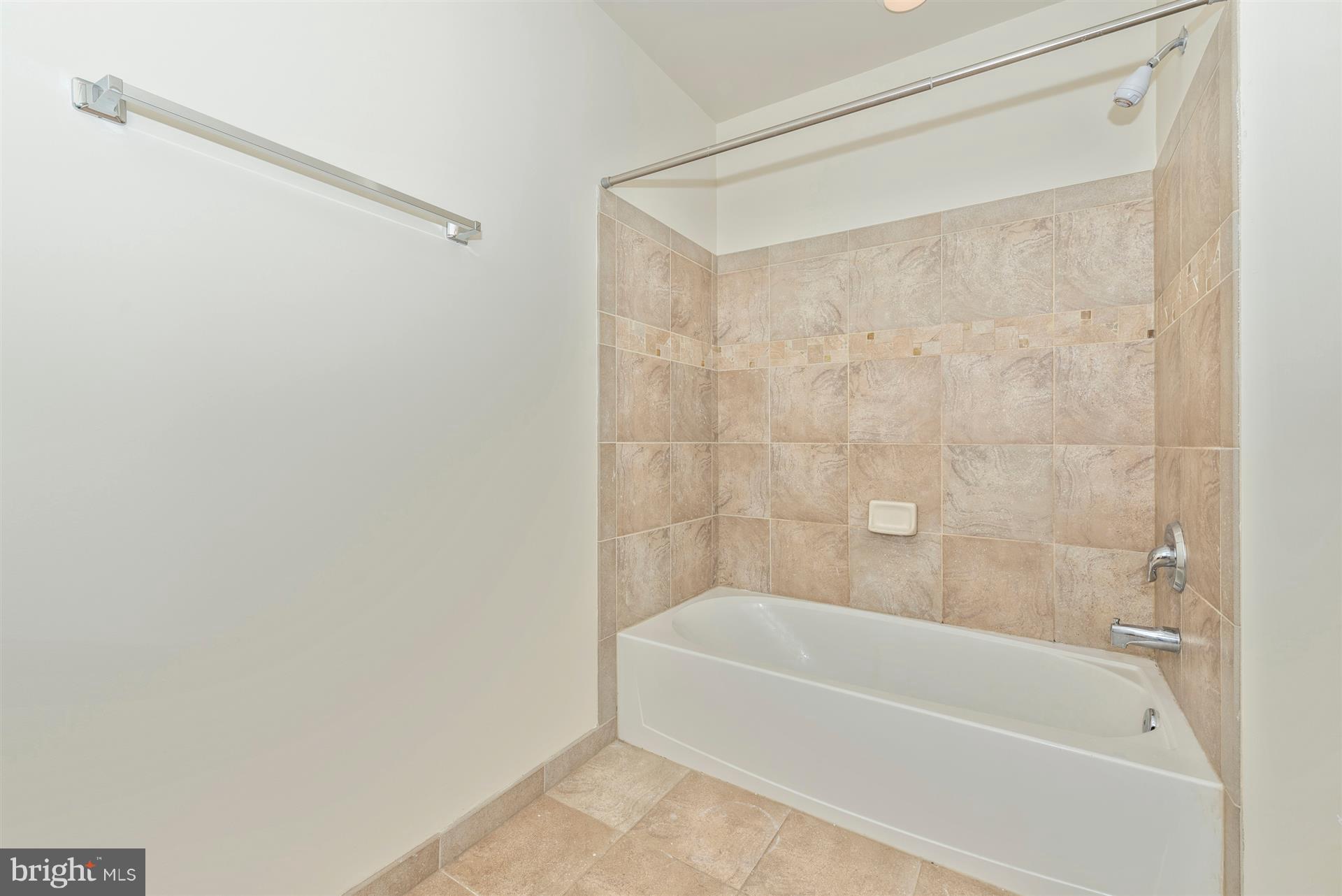129 South Market Street Frederick, MD 21701 - Photo 14 of 37 a bathroom with a bathtub and a shower