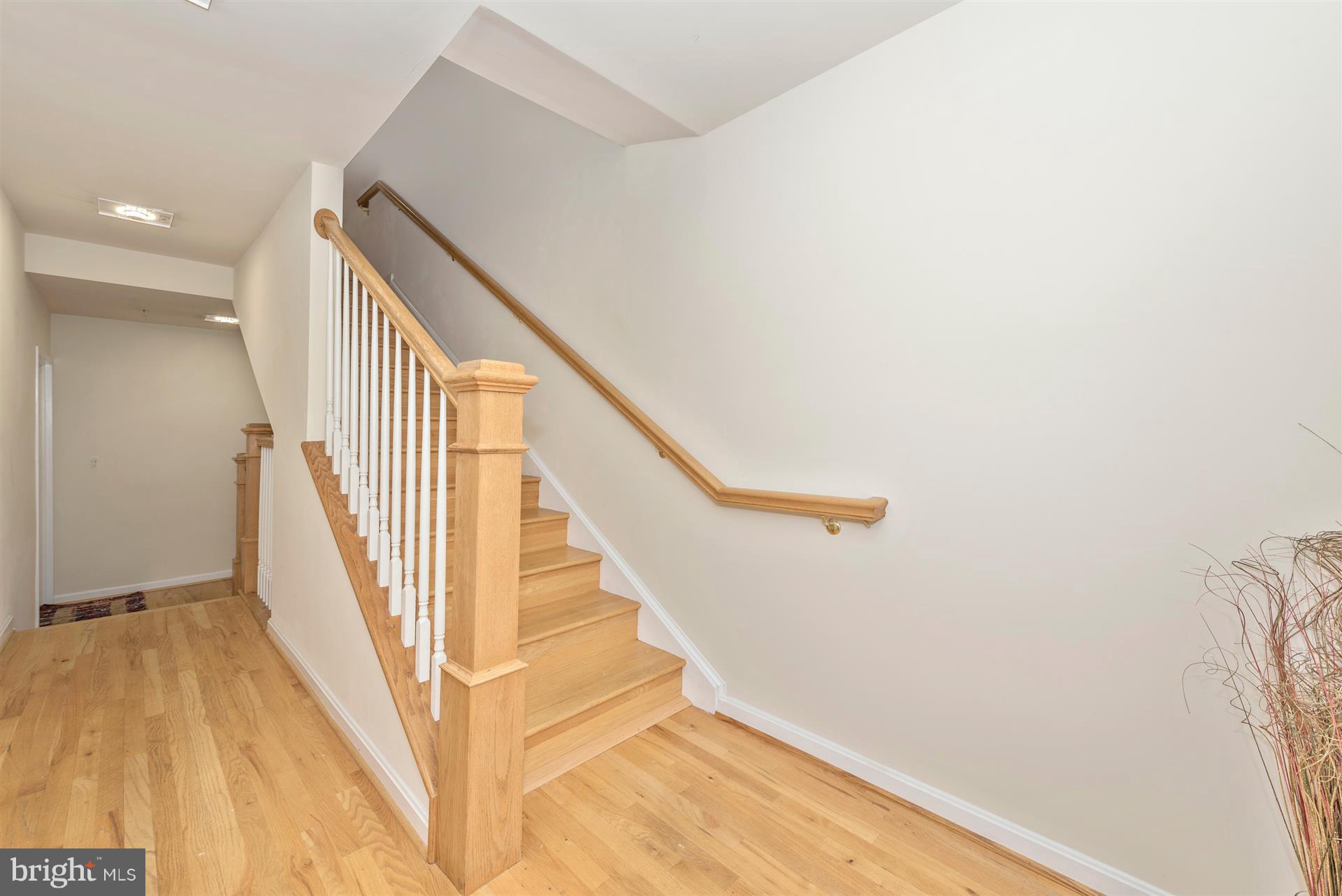 129 South Market Street Frederick, MD 21701 - Photo 15 of 37 a view of staircase with wooden floor and white walls