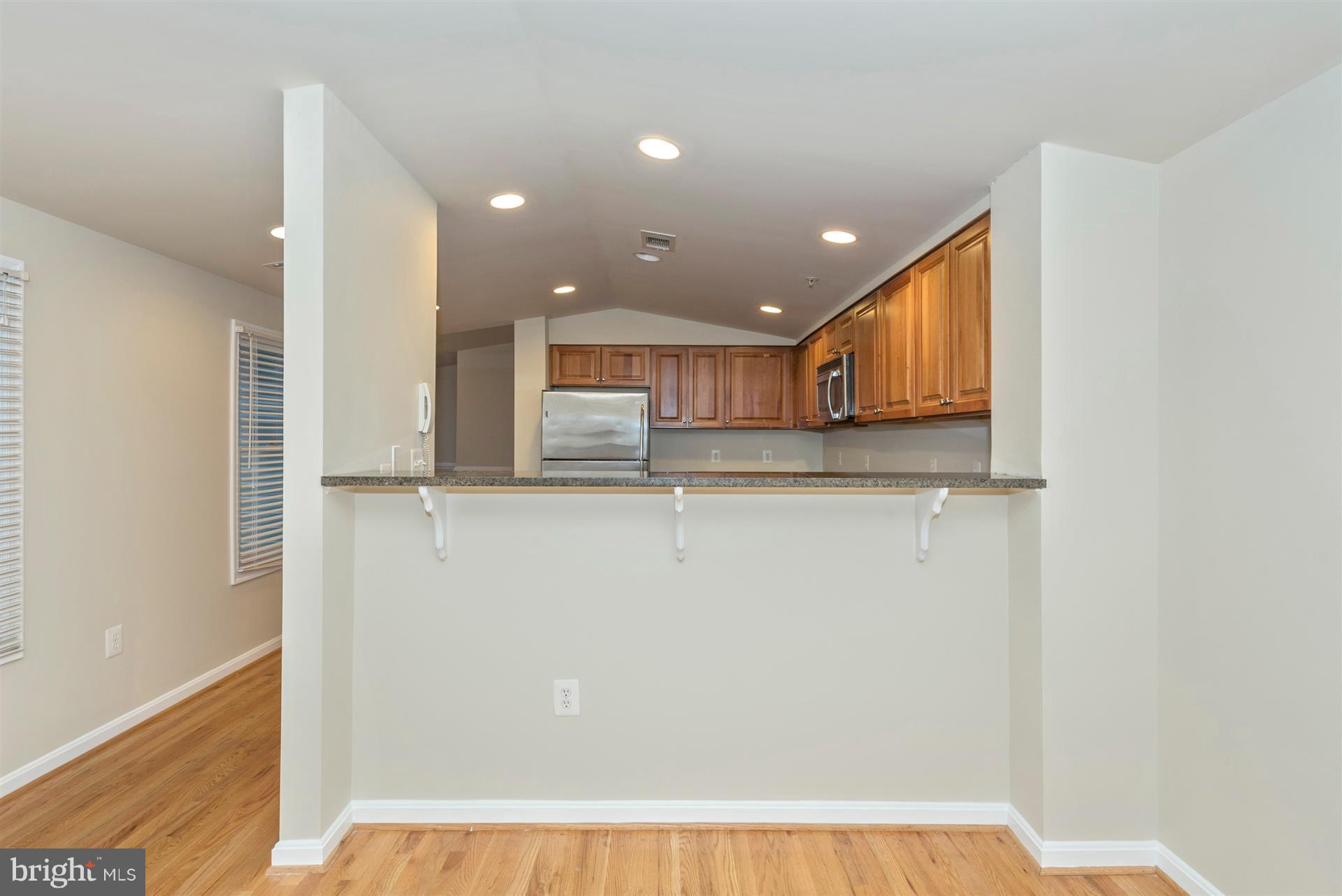 129 South Market Street Frederick, MD 21701 - Photo 21 of 37 a view of kitchen with kitchen island a sink appliances and cabinets