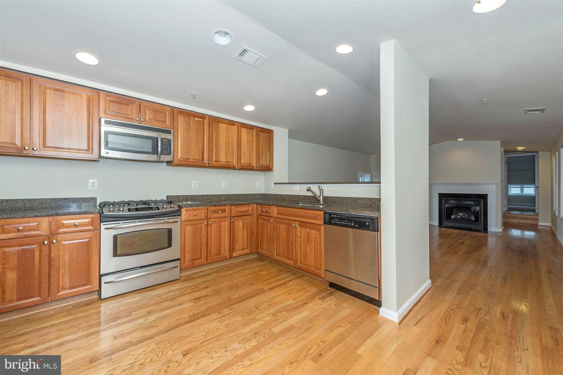 129 South Market Street Frederick, MD 21701 - Photo 22 of 37 a kitchen with stainless steel appliances granite countertop a stove and a sink