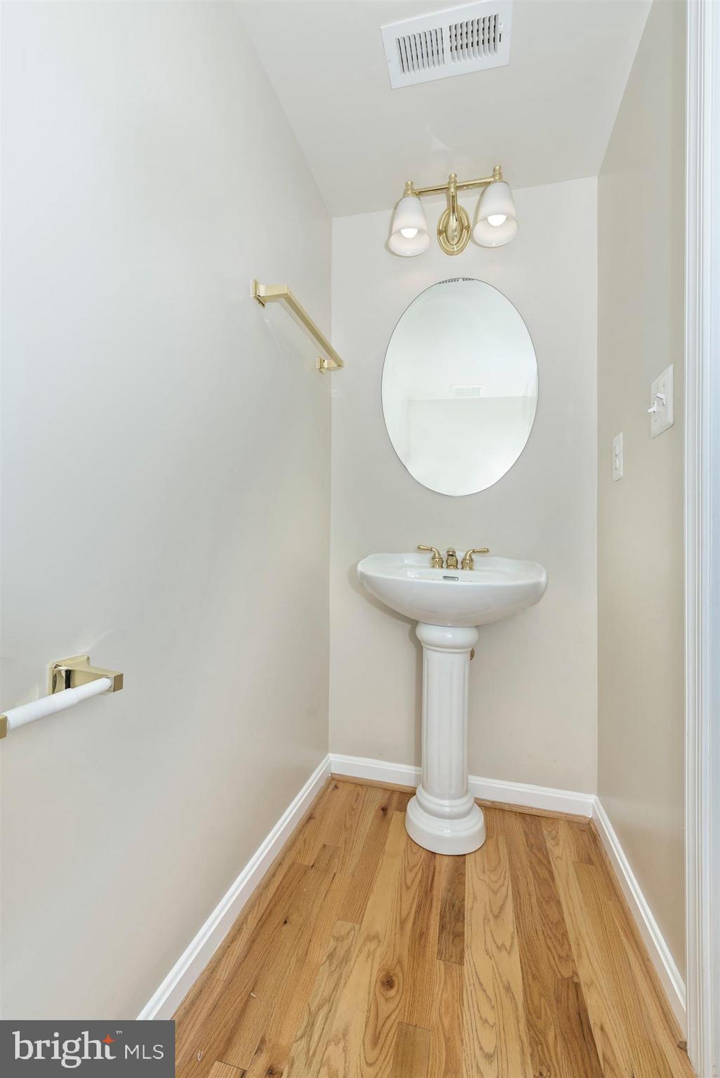 129 South Market Street Frederick, MD 21701 - Photo 25 of 37 a bathroom with a sink and a mirror