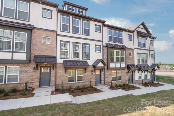 a front view of a residential apartment building with a yard