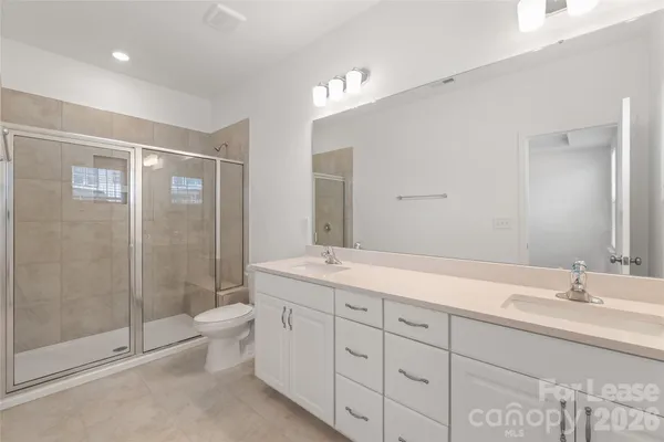 a bathroom with a glass shower door